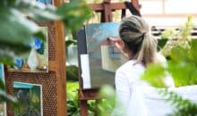 woman painting outside garden